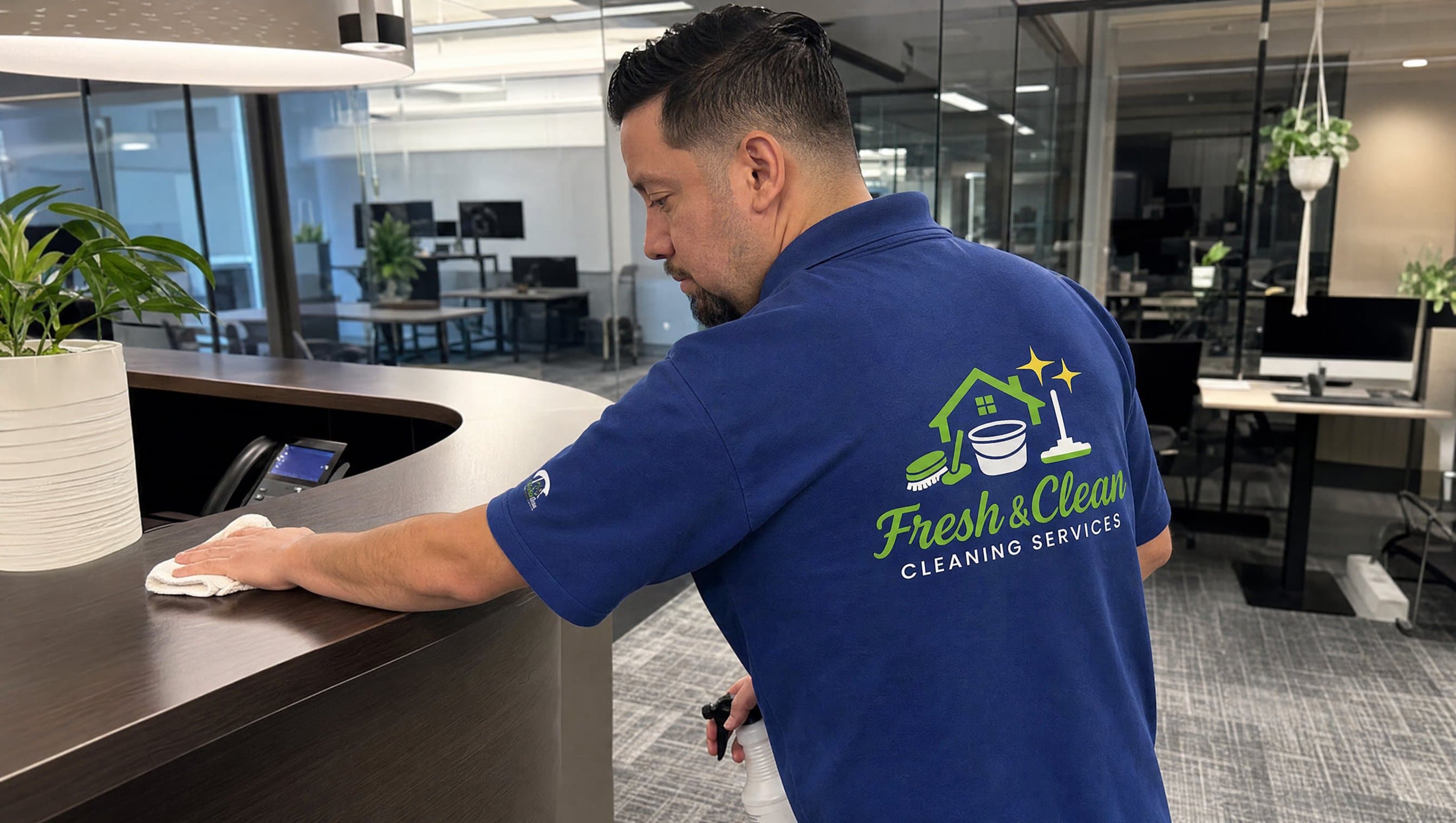 Fresh & Clean staff member cleaning an office reception desk during a commercial cleaning in Montreal